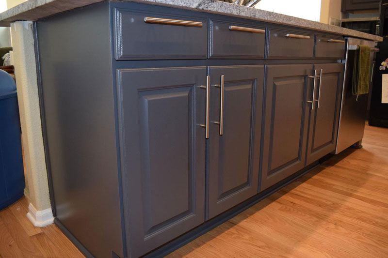 Kitchen island painted slate gray, raised-panel doors and bar pulls