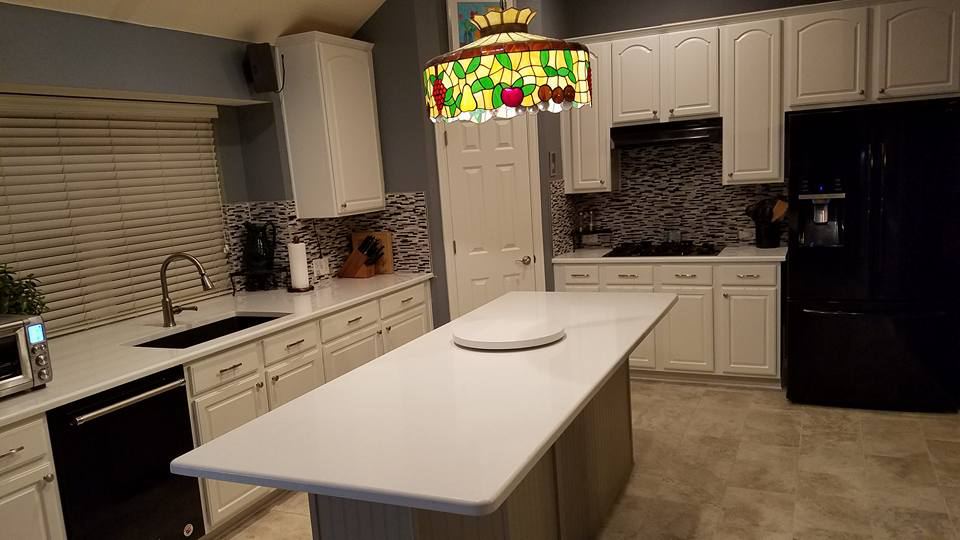 The same kitchen with the cabinets painted white, after