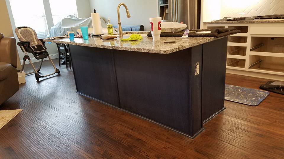 Kitchen island painted espresso brown with a granite top