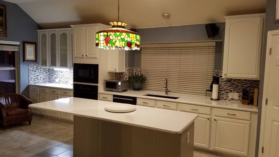 The same wall of cabinets painted white, after