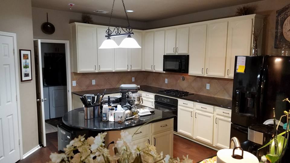 The same kitchen with the cabinets painted white, after