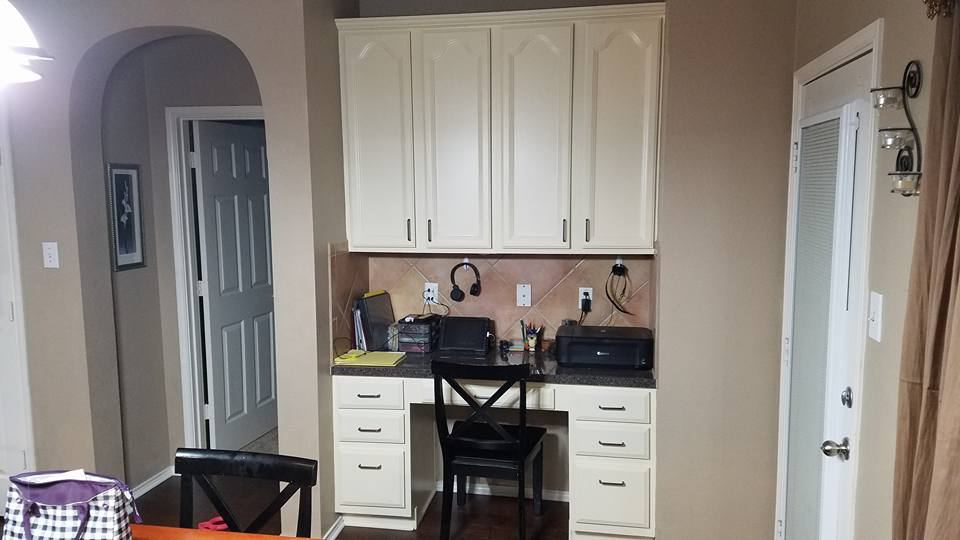 White painted built-in desk cabinets in a kitchen nook