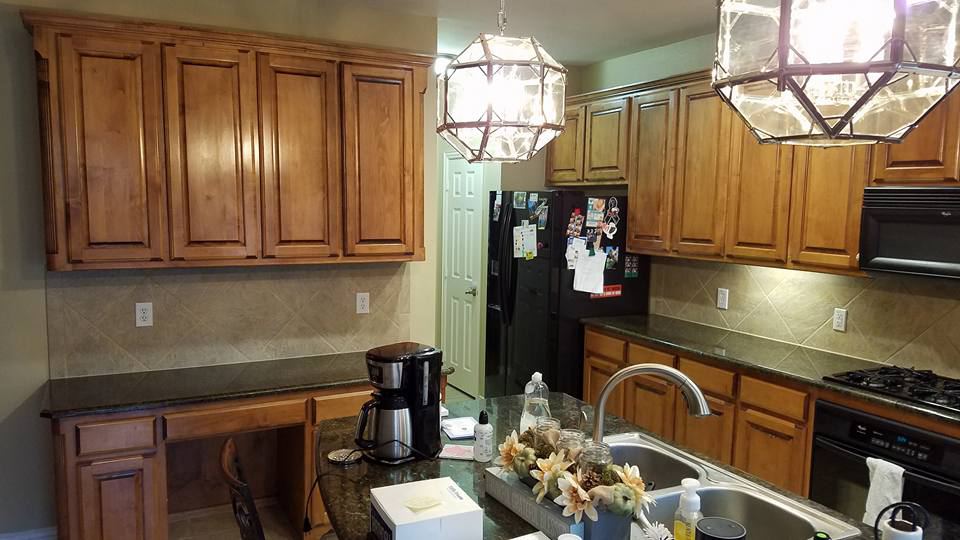 Stained kitchen cabinets and a built-in desk, before painting