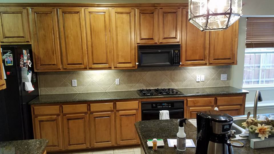 Stained raised-panel kitchen cabinets under an octagon lantern, before painting